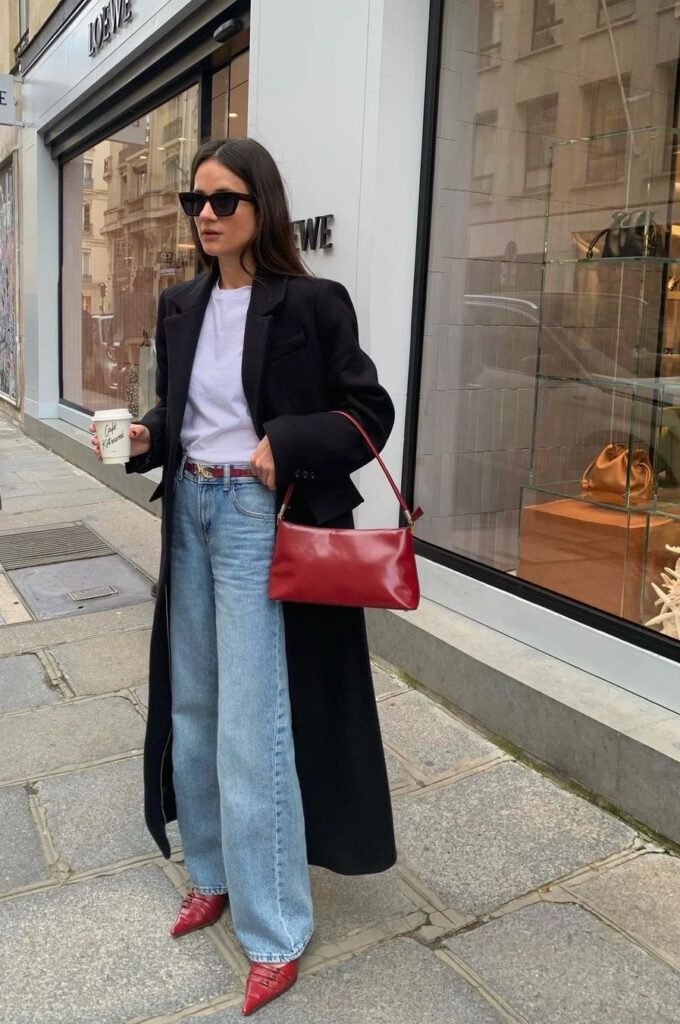 Fashion model wearing mens cut long coat on the streets of Paris