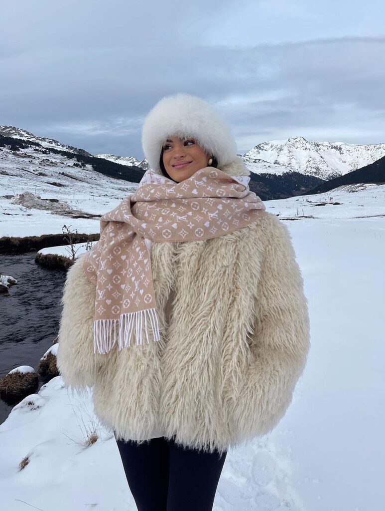 Gorgeous women enjoying in winter land, wearing white fur coat